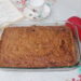 Cinnamon coffee cake with red oven mitt and tea cup